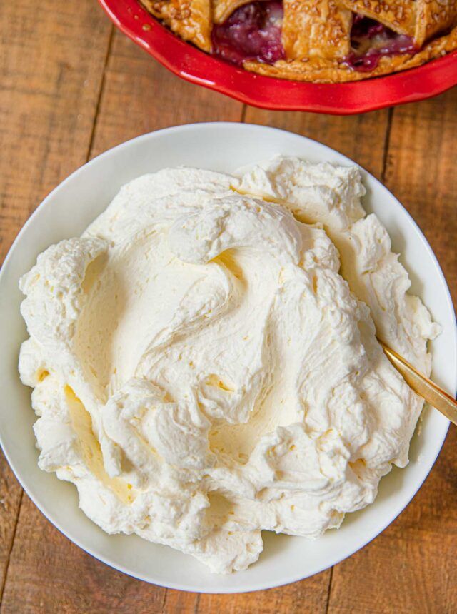 a bowl filled with ice cream next to a pie