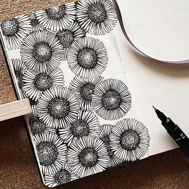 an open notebook with black and white flowers on it