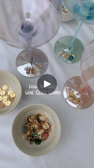 four wine glasses filled with different types of gold coins and some glass goblets