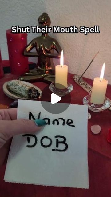 someone is writing name dob on a piece of paper with candles in the background