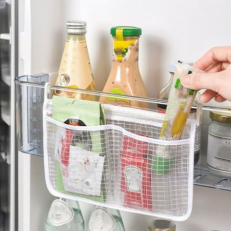 a person is opening the refrigerator door with their food and drinks in baskets on it