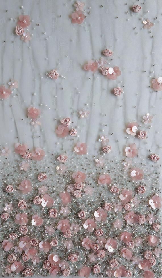 some pink flowers on a white surface with water droplets and bubbles in the air above them