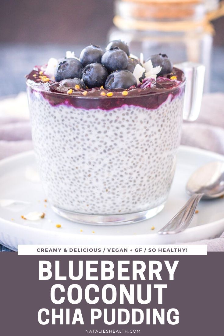 blueberry coconut chia pudding in a glass bowl on a plate with spoons