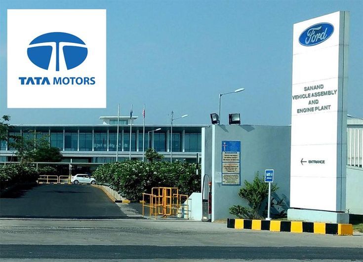 the entrance to tata motors is shown in front of an office building and parking lot