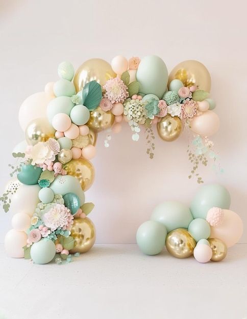 the balloon arch is decorated with pastel colors and flowers