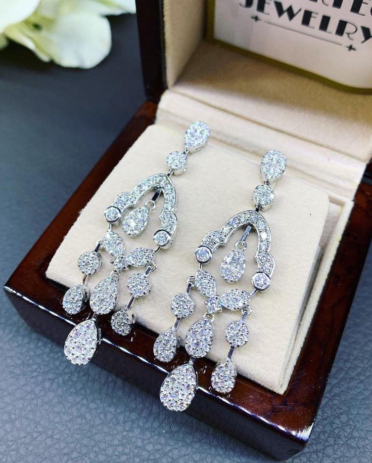 HANDCRAFTED TO PERFECTION! SPECIAL AND LOVELY FLORAL DESIGN, ILLUSION SETTING (APPEARS TO BE LIKE A 0.5-1.0 CARAT BRILLIANT PEAR Diamonds). With over 128 pieces of UNTREATED AND GENUINE F/VS QUALITY SPARKLING DIAMONDS! Perfect for every event! SET IN 18K SOLID WHITE GOLD HANDCRAFTED, CHANDELIER EARRINGS! SUGGESTED RETAIL VALUE: $11,000 DIAMONDS: 254 ROUND BRILLIANT, FULL CUT with excellent firing diamonds, weighting at 3.50 carats. ALL NATURAL, UNTREATED DIAMONDS. ALL DIAMONDS HAVE NO VISIBLE IN Anniversary Diamond Chandelier Earrings With Brilliant Cut, Diamond Chandelier Earrings With Brilliant Cut For Anniversary, Luxury Pear-shaped Chandelier Earrings For Formal Events, Luxury Diamond Chandelier Earrings With Diamond Cut, Elegant White Gold Pear-shaped Chandelier Earrings, White Gold Drop Chandelier Earrings For Evening, Luxury Teardrop Chandelier Earrings With Cubic Zirconia, Diamond White Brilliant Cut Chandelier Earrings For Anniversary, Diamond White Chandelier Earrings With Brilliant Cut For Anniversary