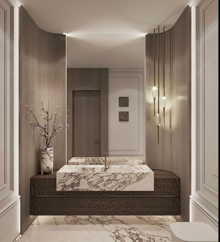 a bathroom with marble counter tops and two sinks