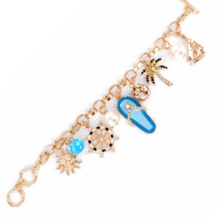 **Beach-Themed Charm Bracelet** - Crystal Accents - Epoxy Details - Faux Pearls - Toggle Closure Gold Metal Charm Bracelet For Beach, Gold Charm Bracelet With Lobster Clasp For Beach, Ocean-inspired Bracelets With Lobster Clasp For Vacation, Beach Charm Bracelet With Lobster Clasp, Metal Charm Bracelet For Beach, Summer Vacation Jewelry With Lobster Clasp, Blue Metal Bracelets For Beach, Ocean-inspired Bracelet For Vacation, Gold Bracelets With Lobster Clasp For Vacation