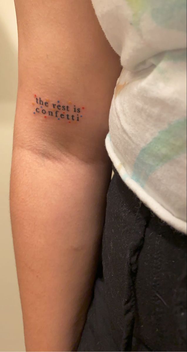 a woman with a tattoo on her arm that says the best is constit