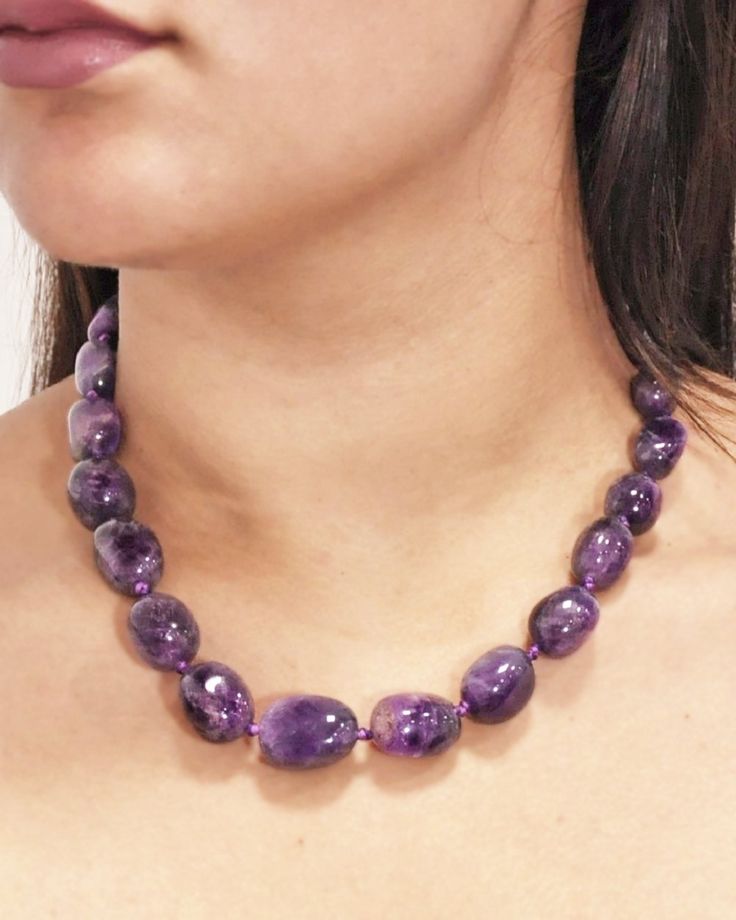 This gorgeous necklace features natural amethyst crystals, in graduating sizes, hand knotted with a silver clasp. Amethyst is a powerful crystal which helps calm the mind while offering powerful meditative and spiritual powers. This elegant healing necklace sits at just the right length on your neckline and completes any look with a royal touch. Amethyst is connected to balancing of the crown chakra and has healing powers to help with physical ailments, emotional issues and balancing. Amethyst c Classic Beaded Necklaces With Gemstone Beads, Elegant Amethyst Beaded Necklaces For Healing, Formal Amethyst Gemstone Bead Necklace, Elegant Amethyst Beaded Necklace For Healing, Elegant Purple Faceted Beads Gemstones, Classic Amethyst Purple Necklace, Elegant Single Strand Amethyst Beaded Necklace, Classic Purple Amethyst Necklace, Classic Purple Round Bead Jewelry