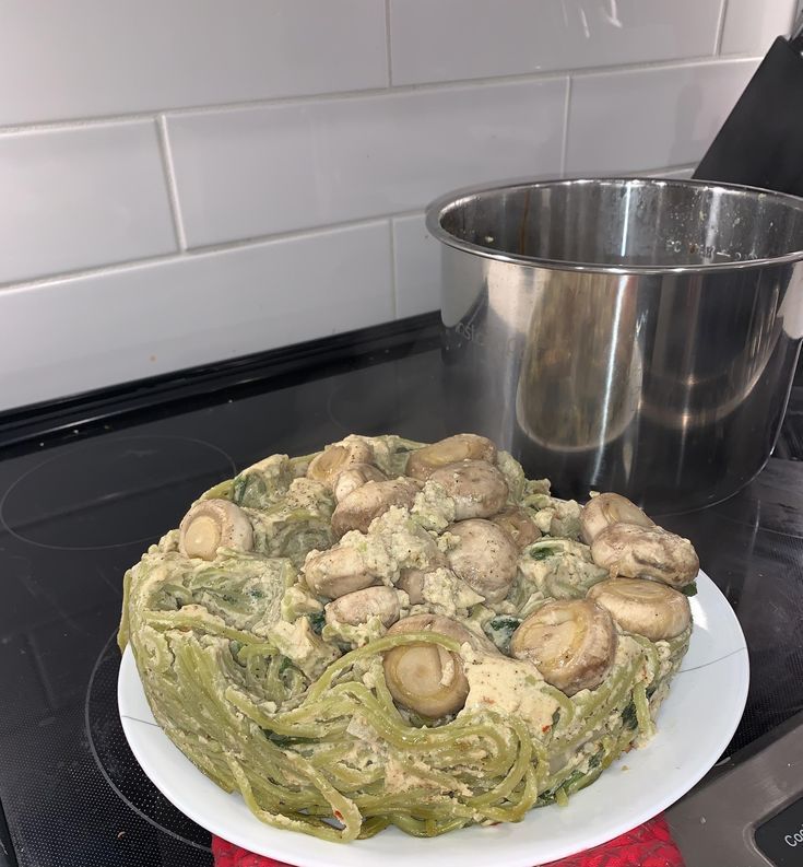 a plate with some food on top of it next to a pot filled with mushrooms