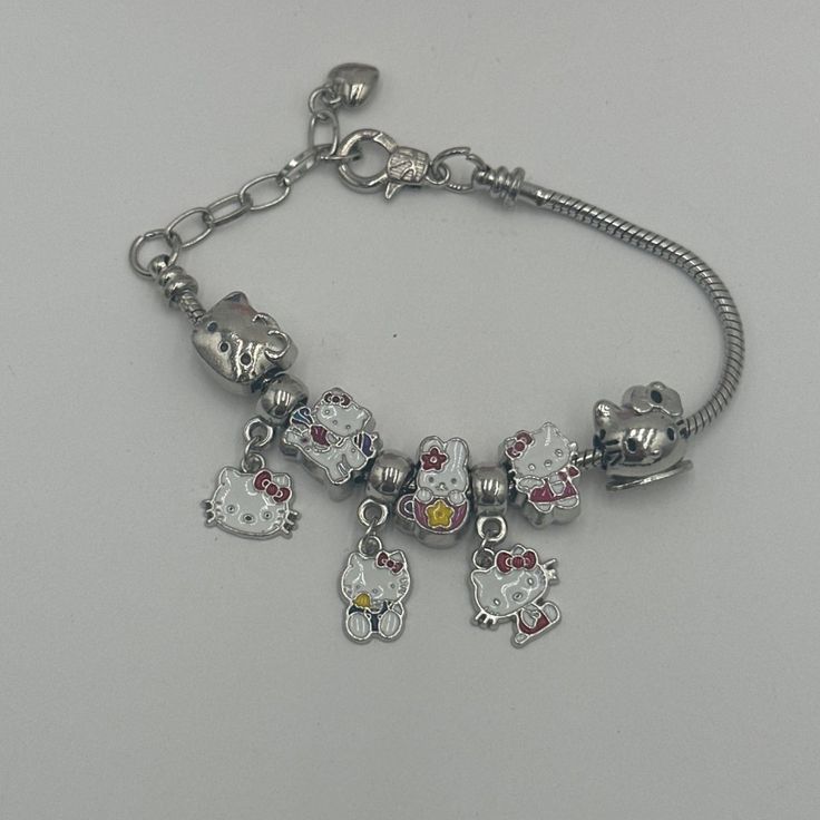 Adorable Hello Kitty Enamel Charm Bracelet Featuring Sanrio Beads. Perfect For Diy Accessories Enthusiasts. Comes Complete With A Gift Box And Bag. Ideal For Hello Kitty Fans. Hello Kitty Themed Charm Bracelet Includes Sanrio Beads Perfect For Diy Accessories Comes With Gift Box And Bag Features: Adjustable Bracelet Size: Womens Os Condition: New With Tags Cute Silver Bracelet Jewelry, Sterling Silver Charm Bracelet With Beads, Silver Beaded Metal Charm Bracelet, Handmade Cute Silver Charms, Cute Handmade Silver Charms, Cute Silver Hypoallergenic Bracelets, Cute Silver Dangle Charms, Cute Hypoallergenic Silver Bracelets, Cute Silver Dangle Jewelry