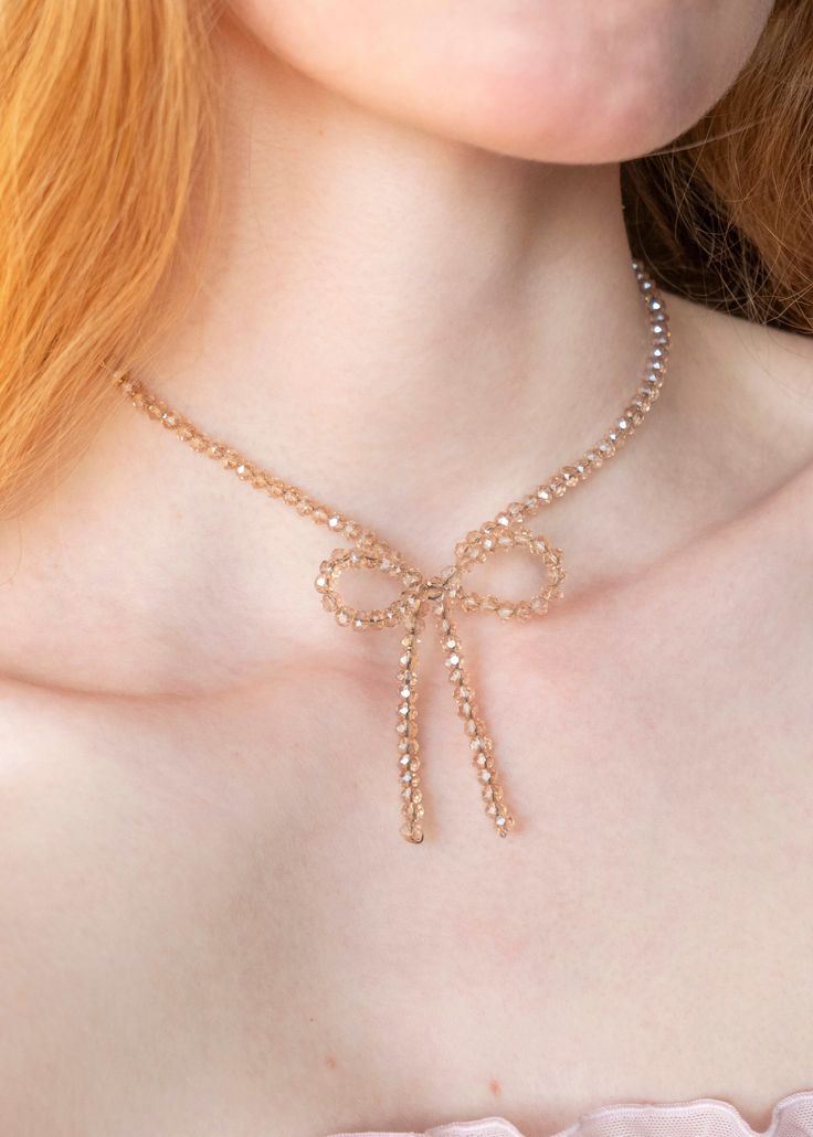 This champagne beaded bow necklace is an intricately, handmade piece of jewelry that goes well with everything. They can easily be dressed up or down for casual and formal/going-out looks, making a great everyday necklace that is still eye-catching and unique. A great amount of care, passion, and attention to detail goes into every step of its creation, making it a truly high-quality and special piece of jewelry that you can feel good about wearing for years to come. This makes the perfect gift Gold Necklace With Decorative Bow For Party, Gold Bow Necklace For Party, Gold Necklace With Bow For Party, Adjustable Necklace With Decorative Bow For Party, Elegant Necklace With Decorative Bow For Party, Beaded Bow Necklace, Beaded Bow, Going Out Looks, Bow Necklace