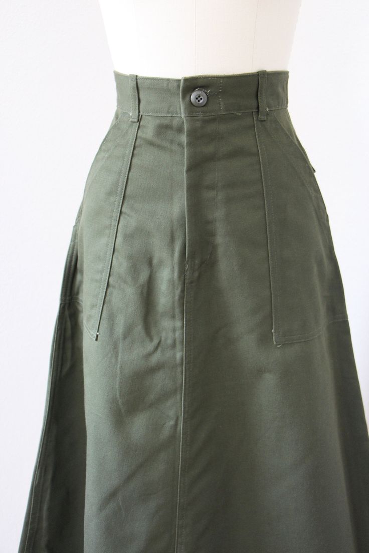 "♛Beautiful 1970s deadstock/unworn skirt is crafted from a high quality cotton twill in a lovely neutral olive green that goes wonderfully with just about every color you can throw at it. This military-inspired skirt is one we are lucky to have in multiples! Super high waist with wide belt loops, front button and metal zipper closure, hip pockets, rear pockets with button closures for a sleek fit, and the perfect A-line shape. All are unworn, made in the USA, and most have their original tags st Retro Flared Skirt With Pockets, Vintage Cotton Flared Skirt Bottoms, Vintage Cotton Flared Skirt, Vintage Full Skirt With Pockets, Retro A-line Cotton Bottoms, Vintage Long Skirt With Relaxed Fit, Retro Cotton Skirt With Pockets, Vintage Fitted Cotton Skirt, Vintage Cotton Lined Skirt