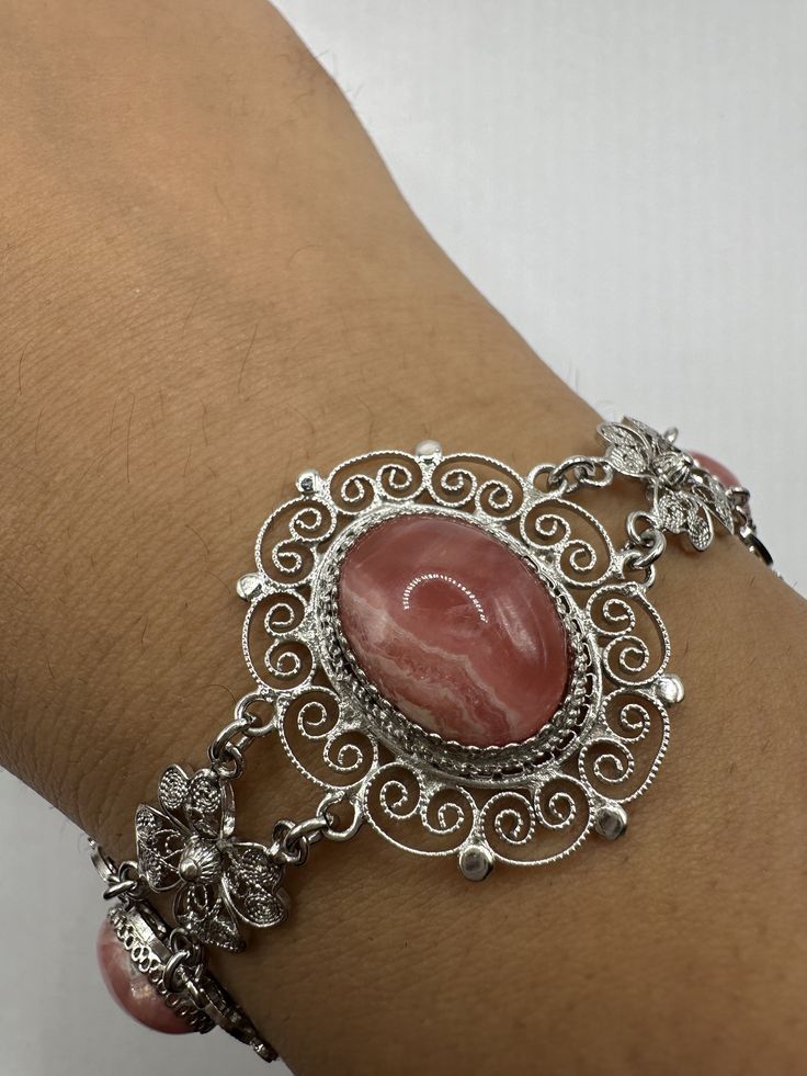 Vintage sterling silver Deco design  Wrap around 7.5 inch bangle fits 5-8 inch wrist. Set with large pink rhodochrosite  All hand made filligree  All jewelry is shipped in a nice gift box.   Check out our over a THOUSAND great reviews Engraving is $4 per letter and is not always perfect depending on the piece. It can take a few days if the jeweler is busy. This is payable to Paypal Judithsltd@gmail.com Decorative Pink Jewelry Gift, Elegant Adjustable Pink Sterling Silver Bracelet, Elegant Pink Nickel-free Bracelets, Pink Gemstone Bangle Jewelry, Ornate Pink Jewelry For Gifts, Ornate Pink Jewelry Gift, Elegant Pink Decorative Jewelry, Ornate Oval Bracelets For Gifts, Decoupage Jewelry