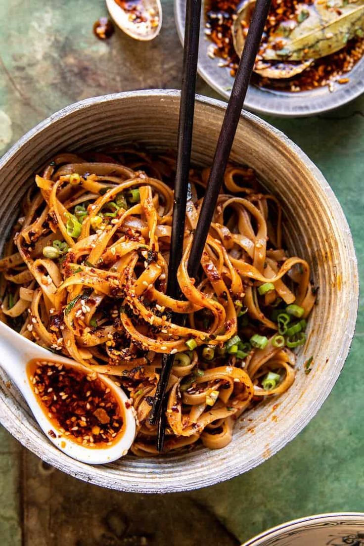 a bowl filled with noodles and sauce on top of a table