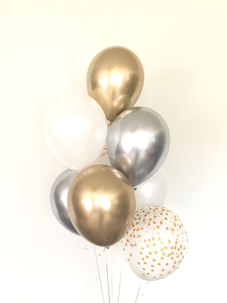 a bunch of balloons that are in the shape of stars on a white background with gold and silver confetti