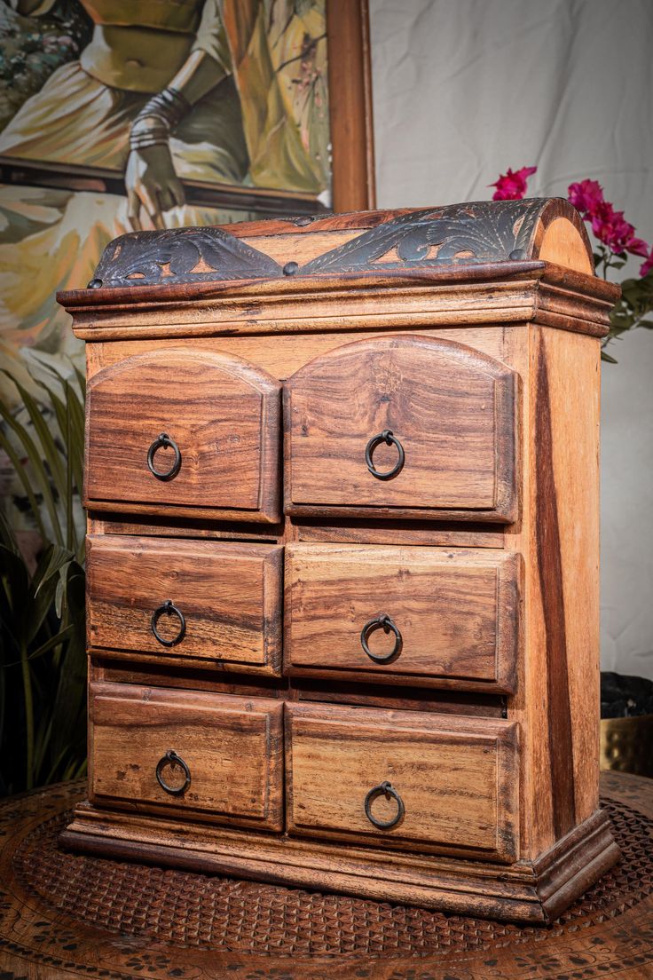 a wooden dresser with drawers on top of it