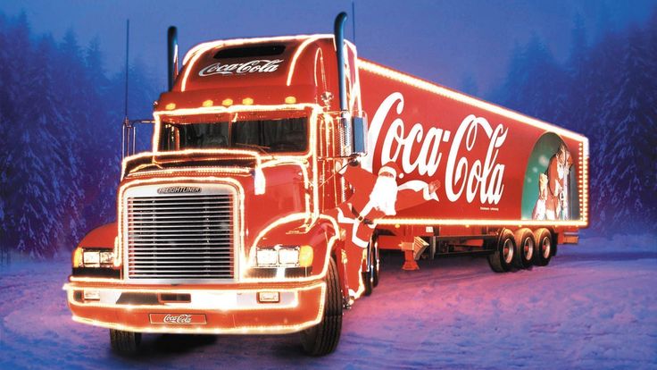 a coca - cola truck is driving through the snow