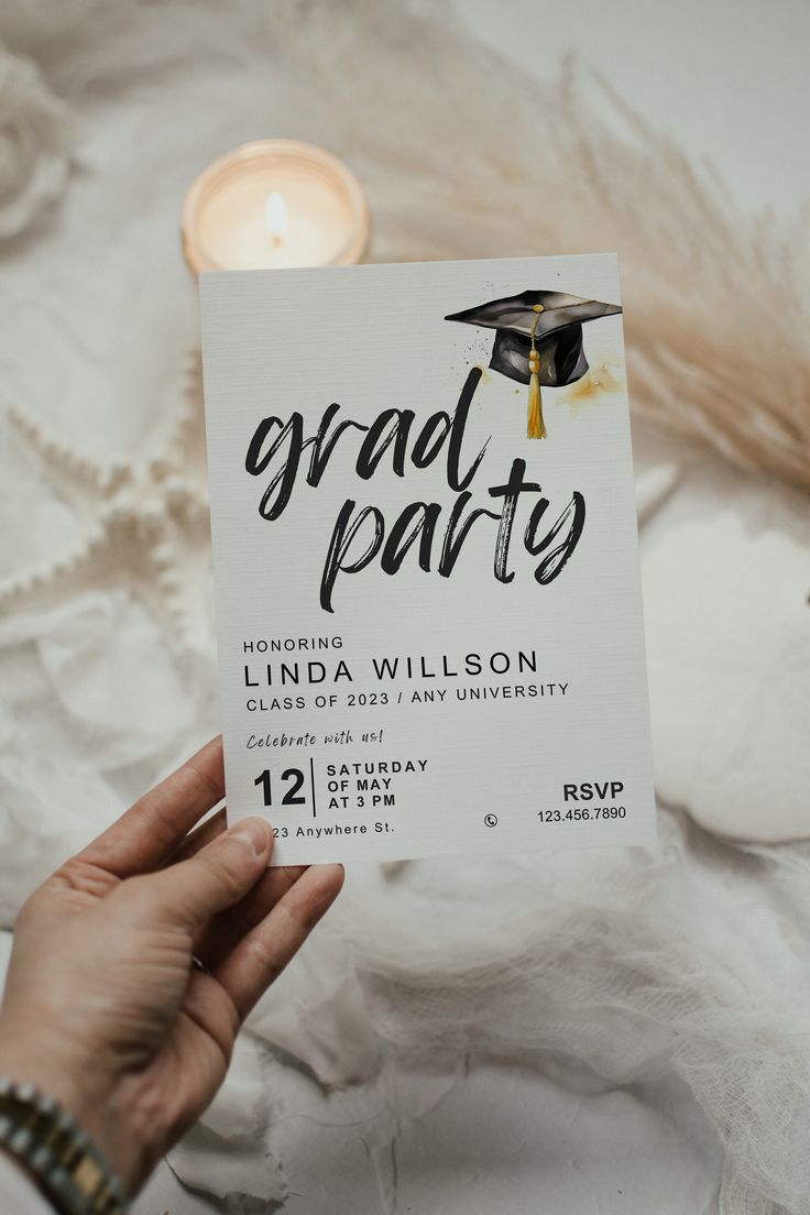 a person holding up a card that says graduate party with a graduation cap on it