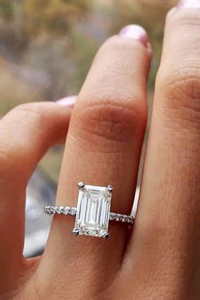 a woman's hand with a ring on it and a baguette in the middle