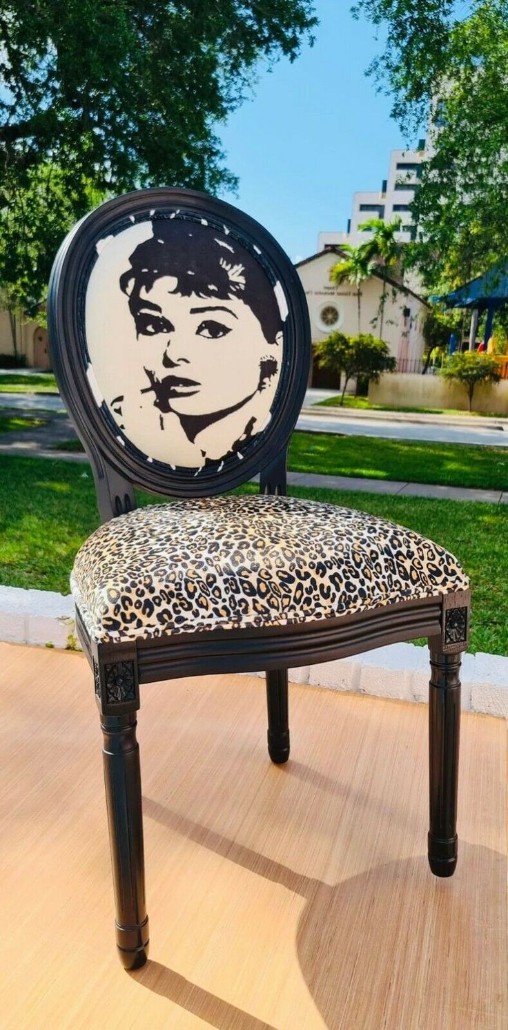 a leopard print chair sitting on top of a wooden floor