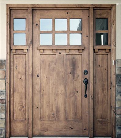 a wooden door with glass panels on it