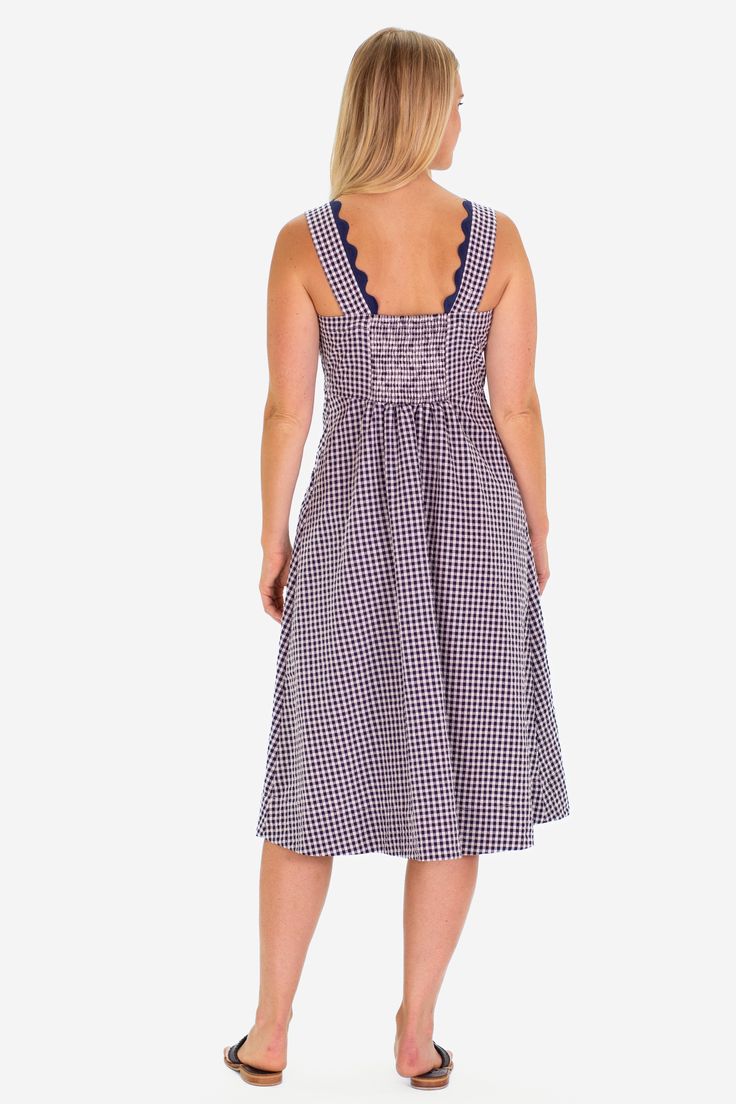 The RicRac Wendy dress is the perfect pop of spring, ready to take you to the farmers market, brunch, and a sunny shopping day FEEL: The classic Navy Gingham is a woven fabric that is breathable yet will withstand many seasons of wear. (50% polyester, 50% cotton) FAVORITE FEATURES: Scallop neckline detail Midi length Thick tank strap-bra friendly! Spring Cotton Smocked Dress For Brunch, Cotton Sundress With Smocked Back For Brunch, Picnic Gingham Sundress With Ruffles, Spring Gingham Sundress With Ruffles, Picnic Plaid Midi Dress With Ruffles, Plaid Midi Dress With Ruffles For Picnic, Sleeveless Summer Plaid Dress For Brunch, Sleeveless Plaid Dress For Summer Brunch, Spring Beach Dress In Gingham