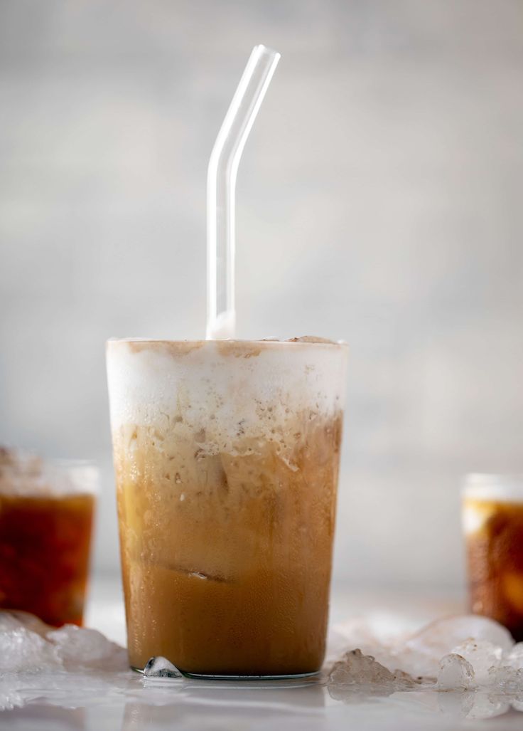 an iced drink with two straws sticking out of it