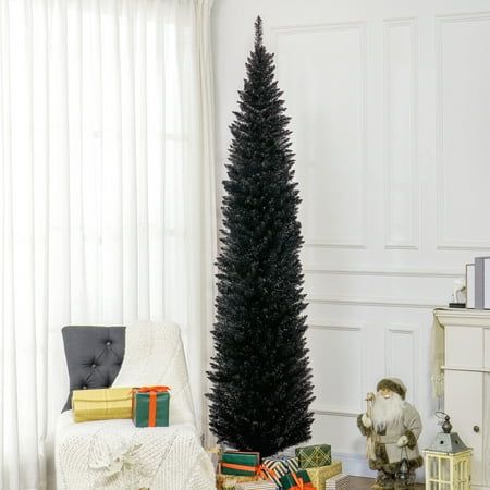 a christmas tree in the corner of a living room with presents on the floor next to it