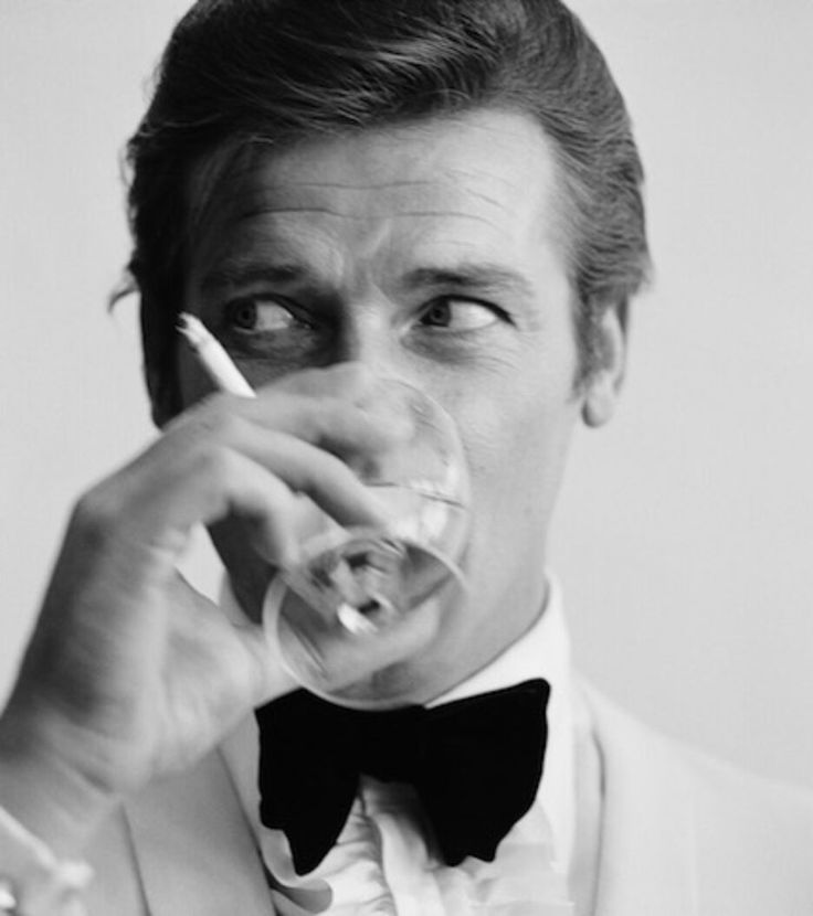 All of the James Bond cocktails | Gentleman's Journal Roger Moore 007, Shaken Not Stirred, Rudolf Nureyev, Roger Moore, Slim Aarons, Photographie Inspo, Bond Films, Barbra Streisand, Vogue Covers