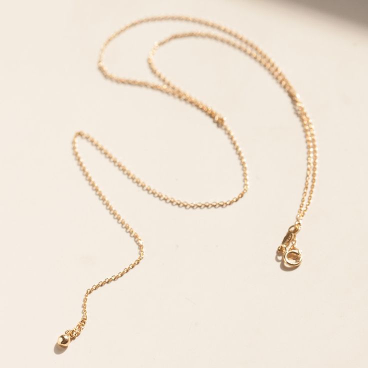 We love all things tiny, shiny and gold. Minimalist Gold Body Chain, Gold Delicate Chain Body Chain Gift, Fine Jewelry Lariat Necklace With Adjustable Chain, Gold Lariat Body Chain As Gift, Gold Lariat Body Chain Gift, Minimalist Delicate Chain Lariat Necklace For Formal Events, Minimalist Long Backdrop Necklace With Adjustable Chain, Elegant Gold Body Chain With Delicate Chain, Minimalist Lariat Chain Necklace