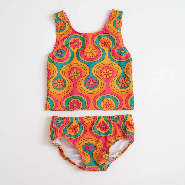 This groovy two piece swimsuit will look so cool on your little girl while she enjoys summer fun in the sun. Featuring a groovy flower and geometric print, this swimsuit is an easy upgrade on her summer wardrobe. The back features faux bows for a cool, unique style. Faux Bows, Flower And Geometric, 70s Vibes, 60s Style, Two Piece Swimsuit, Baby And Toddler, Fun In The Sun, 60s Fashion