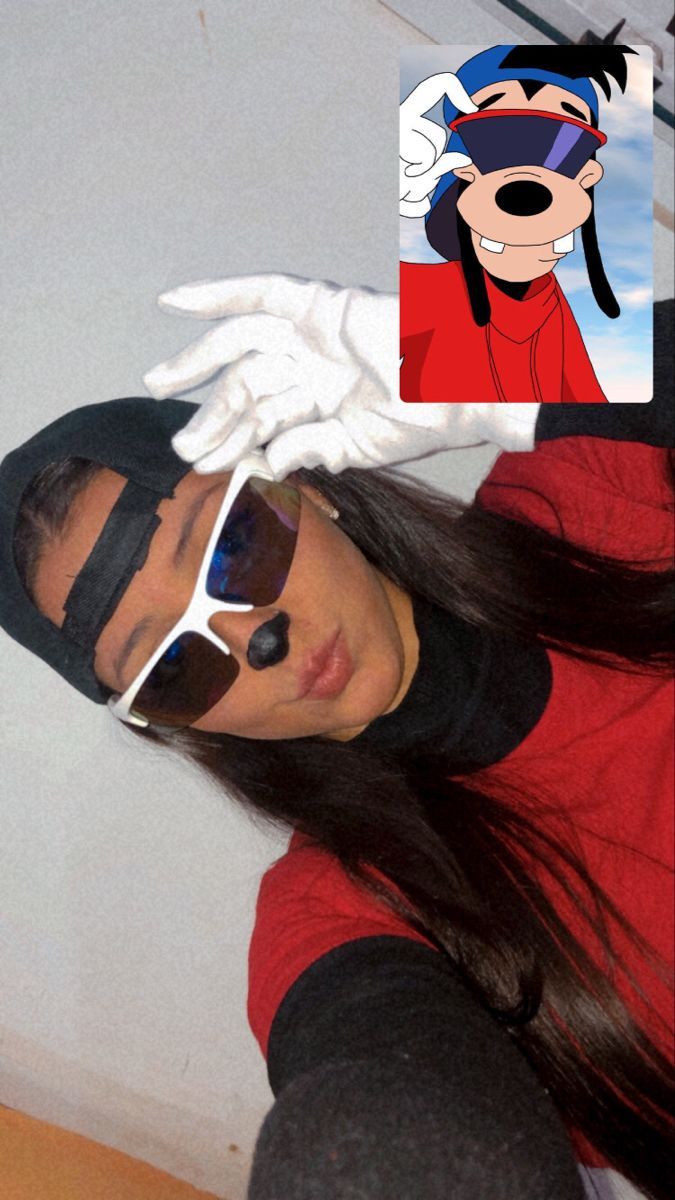 a woman wearing sunglasses and a mickey mouse mask