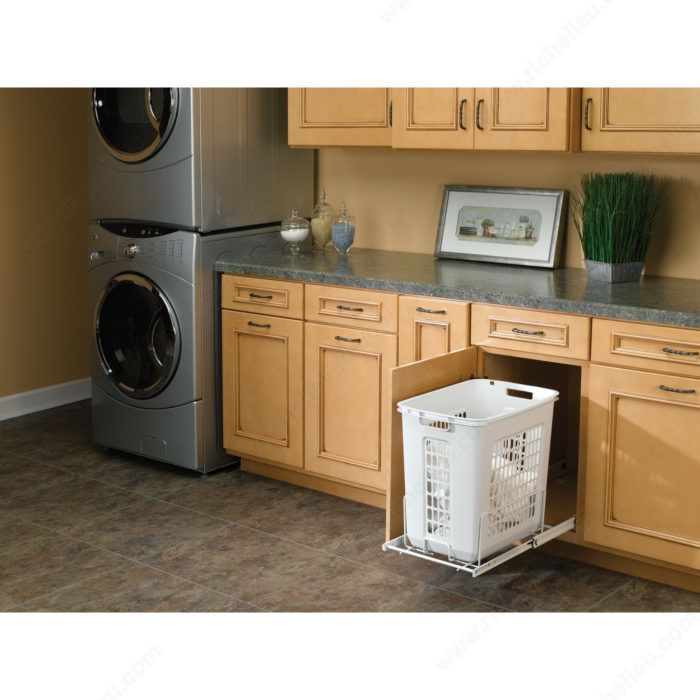 a washer and dryer sitting in a kitchen next to each other on the floor