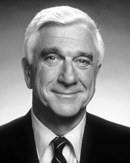 black and white photograph of an older man wearing a suit with a striped neck tie