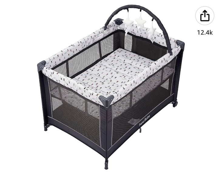 a baby crib that is black and white with stars on the top, in front of a white background