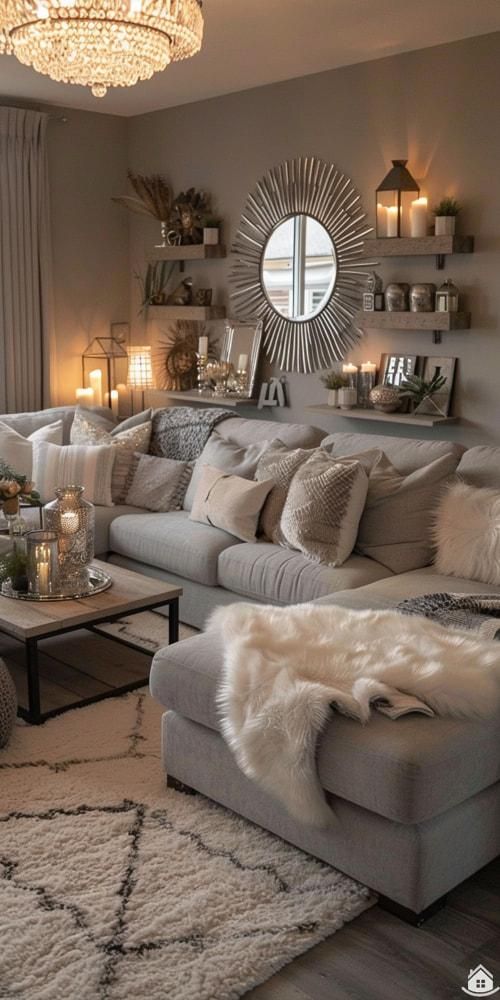 a living room filled with furniture and a chandelier above the couches in front of a window