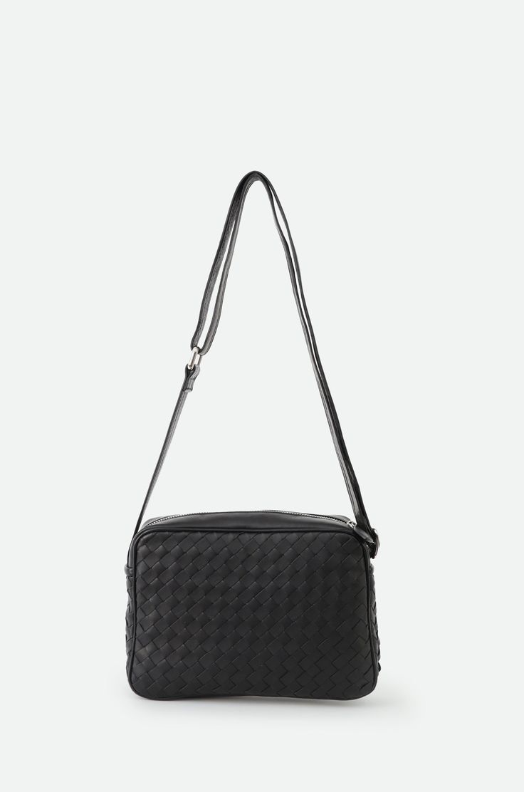 Presenting the Bari Bag—a statement of elegance and timeless charm. With its distinctive woven design and slim silhouette, this bag seamlessly complements any outfit, exuding a sense of relaxed sophistication. Meticulously handcrafted in Italy, using the finest lambskin leather, it epitomizes luxury and quality. Perfect for everyday wear and travel with a zippered closure, the Bari combines style with functionality, ensuring you stand out with every step. Details: Handmade in Italy Crafted from 100% smooth lambskin leather Designed by Segatta & Roth Complete inner lining Dimensions: 6 1/2" height, 9 1/2" width X 2 1/2" length Adjustable Strap length 34"-57" Includes an inner zippered pocket Product Code: ART.PI-106, BLACK Italian Leather Bags, Code Art, Everyday Chic, Woven Design, Woven Bag, Style Expert, Leather Design, Lambskin Leather, Italian Leather