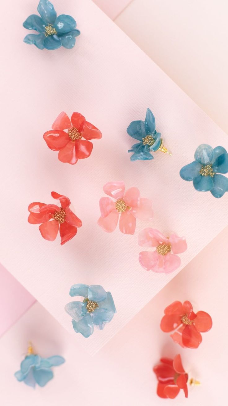 six different colored flowers are placed next to each other on a piece of white paper