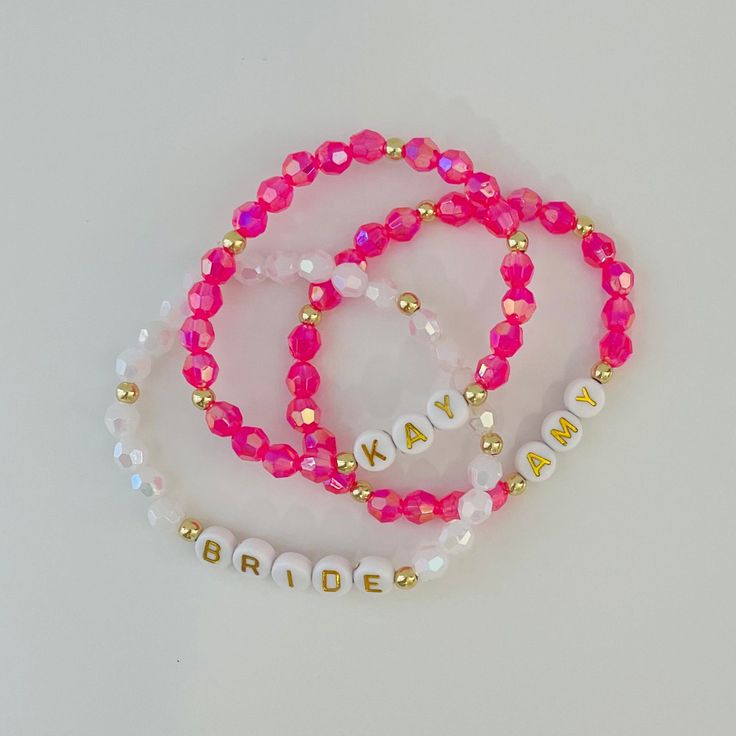 Welcome to CraftylilStudio!  This listing is for ONE personalized  bracelet. 🌸These sparkly bracelets are a Perfect gift for a bridesmaid, friend or just for yourself. Bracelets come in organza string bags, perfect for gifting. 😊 DETAILS: -Each bracelet is handmade just for you!  -Made with Iridescent Acrylic beads and 18k gold plated accents.  -Made with High quality clear jewelry elastic cord. -Leave Name or word and Letter bead style  number in personalization box at checkout. Pleaso also use personalization box to leave  custom size  if chosen from drop down menu.  -All orders are FINAL as each bracelet is custom made. Please measure your wrist and spelling  before purchasing.  -Measure wrist were you want the bracelet then add 1/2 an inch to that measurement. This will account for b Customized Pink Jewelry For Personalized Gift, Pink Personalized Bracelet As A Gift, Handmade Bracelets For Bridesmaid Gift, Customized Pink Bracelet As Gift, Gold Beaded Bracelets For Wedding And Valentine's Day, Personalized Pink Beaded Jewelry, Handmade Adjustable Beaded Bracelets For Bridesmaids, Handmade Adjustable Beaded Bracelets As Bridesmaid Gifts, Elegant Personalized Crystal Wedding Bracelet