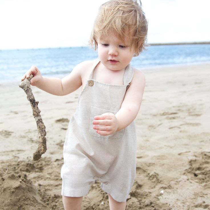 Perfect for summer days romping at the beach or every day, these gorgeous button overalls come in a gorgeous sand colour stripe, and featured press studs for easy nappy changes. Summer Vacation Overalls, Summer Overalls For Vacation, Summer Shortalls For Beach, Spring Beach Shortalls Overalls, Spring Beach Shortalls Overall, Summer Beach Shortalls Overall, Summer Beach Shortalls, Beach Style Summer Shortalls, Spring Beach Shortalls