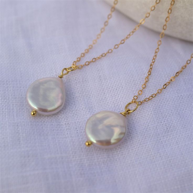 Natural Freshwater Baroque Coin pendant comes on a 14 K gold-filled chain. It is a perfect statement piece and a great necklace to style solo or layered with other necklaces. Please note: each pearl is unique, no two are the same ,  but they all are beautiful. Details: - Baroque coin white pearl size 13-14 mm, very good luster  - Pearl is set on a sterling silver gold plated headpin. - 14 K gold-filled chain with a lobster clasp. - Chain's length : 35 cm ( 14 inch), 40 cm ( 16 inch), 45 cm ( 18 inch), 50 cm ( 20 inch) ► PACKAGING / GIFT BOX All jewellery is carefully packed in our signature Sparklez jewellery box. To reduce waste, we often put an order with multiple pieces in one or two gift boxes. If you would like your order to be boxed separately or if only part of your order is intende Gold Dangle Charm Necklace With Pearl Drop, Wedding Necklace With Delicate Gold-plated Chain, Teardrop Gold Plated Necklace For Wedding, Gold Plated Teardrop Necklace For Wedding, Gold Plated Delicate Chain Necklace For Wedding, Gold Wedding Necklace With Pearl Chain, Gold Pearl Bridal Necklace With Delicate Chain, Yellow Gold Pearl Drop Necklace For Wedding, Rose Gold Charm Necklace With Adjustable Chain For Wedding