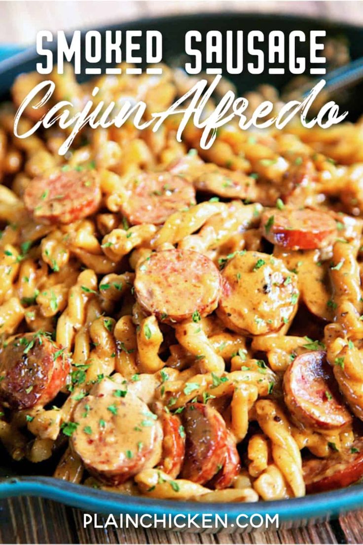 a bowl full of smoked sausage and pasta with the words smoked sausage cajun alfredo