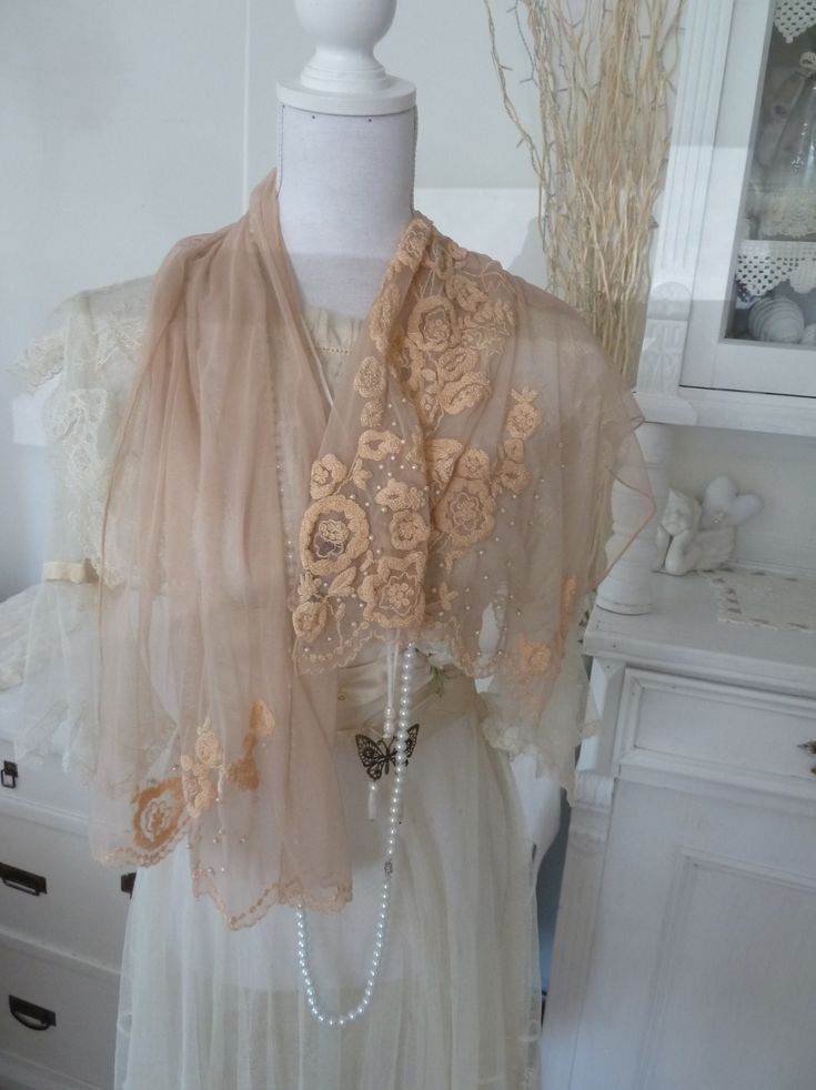 **A dream of tulle, pearls and fine embroidery** Here I have an enchanting apricot/beige scarf made of fine soft tulle for you with a delicate embroidered flower motif and pearl decoration. The tulle is beige and the embroidery appliqués are a bit apricot, they harmonize wonderfully together. It was processed to a very high standard, i.e. every single bead was sewn on and the embroidery was also done by hand. Thus, it is reminiscent of the Edwardian era in its noblest time, the Titanic era. Ther Elegant Beige Lace With Floral Embroidery, Feminine Cream Lace For Wedding, Elegant Cream Embroidered Shawl, Elegant Cream Tulle Veil, Elegant Embroidered Tulle Lace, Elegant Cream Lace Shawl, Elegant Beige Shawl For Spring, Beige Lace For Spring Wedding, Spring Wedding Beige Lace