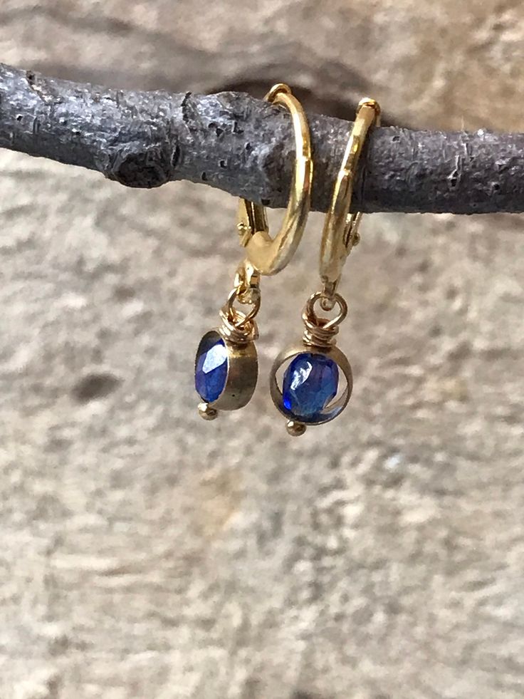 Lovely tiny gold hoop earrings with a touch of sapphire blue dangling ever so slightly. The Huggie hoops are sterling silver and plated with gold. From these tiny hoops hangs a sapphire blue vintage glass bead inside a small brass hoop. The total length of these earrings is less than an inch, making them great every day earrings. The lever back makes them easy to use... another bonus for everyday wear. All orders are shipped in recycled packaging. Nickel-free Blue Small Hoop Jewelry, Blue Small Hoop Huggie Earrings, Blue Hypoallergenic Small Hoop Huggie Earrings, Hypoallergenic Blue Small Hoop Huggie Earrings, Blue Small Hoop Huggie Earrings For Everyday, Dainty Gold Plated Nickel Free Huggie Earrings, Blue Hypoallergenic Small Hoop Jewelry, Hypoallergenic Blue Small Hoop Jewelry, Blue Hoop Brass Jewelry