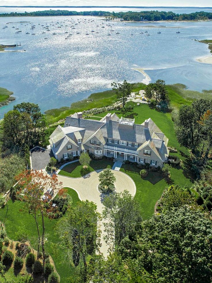 this is an aerial view of the house and its surrounding grounds, with boats in the water