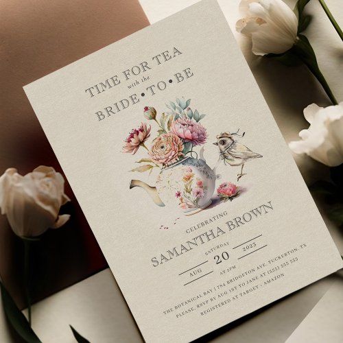 the wedding card is next to flowers and a vase with two birds on it's side