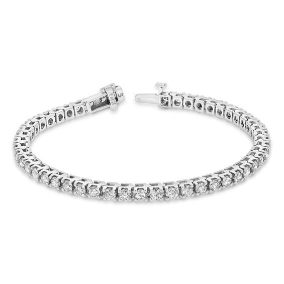 Dress her wrist in the wearable luxury of this sparkling diamond tennis bracelet. Crafted in cool 14K white gold, this beautiful streamlined design features dazzling 1/10 ct. diamonds, each with a color rank of I and clarity of I1. Captivating with 5 ct. t.w. of diamonds and a bright polished shine, this stylish 7.0-inch tennis bracelet closes securely with a box clasp. White Gold Tennis Bracelet With Diamond Accents, Platinum Tennis Bracelet With Diamond Accents, Platinum Diamond Bracelet With Diamond Accents, Timeless White Gold Tennis Bracelet With Diamond Accents, Classic White Gold Diamond Bracelet With Accents, Timeless White Gold Diamond Tennis Bracelet, Modern Diamond White Platinum Tennis Bracelet, Modern Diamond Tennis Bracelet With Brilliant Cut, Modern Diamond Bracelet With Prong Setting