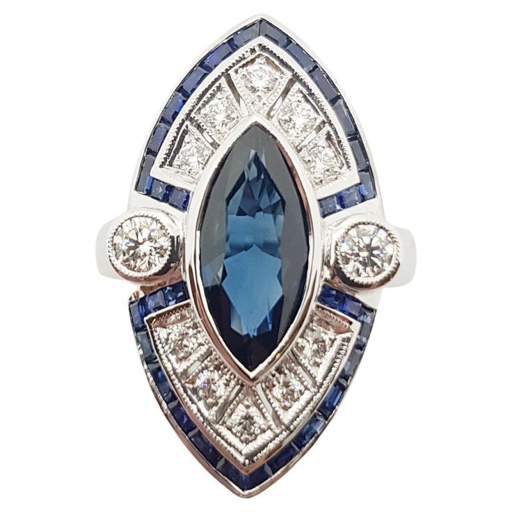 Blue Sapphire 2.62 carats with Diamond 0.49 carat and Blue Sapphire 1.30 carats Ring set in 18 Karat White Gold Settings Width: 1.5 cm Length: 1.7 cm Ring Size: 55 Total Weight: 10.72 grams "We first opened doors in 1980 when it was then situated in the vicinity of the Victory Monument; a small and modest storefront with a couple of counters. From its humble beginnings to where it stands today, our company has proven its abilities as a jeweler. Since the beginning, we have been supplying fine qu Marquise Sapphire Ring In White Gold With Vvs Clarity, White Gold Marquise Sapphire Ring With Vvs Clarity, Marquise White Gold Sapphire Ring With Vvs Clarity, Luxury Sapphire Ring With Marquise Cut, Luxury Marquise Cut Sapphire Ring, Luxury Blue Marquise Cut Jewelry, Blue Marquise Brilliant Cut Jewelry, Marquise Sapphire Diamond Ring With Diamond Cut, Blue Art Deco Diamond Ring With Diamond Cut